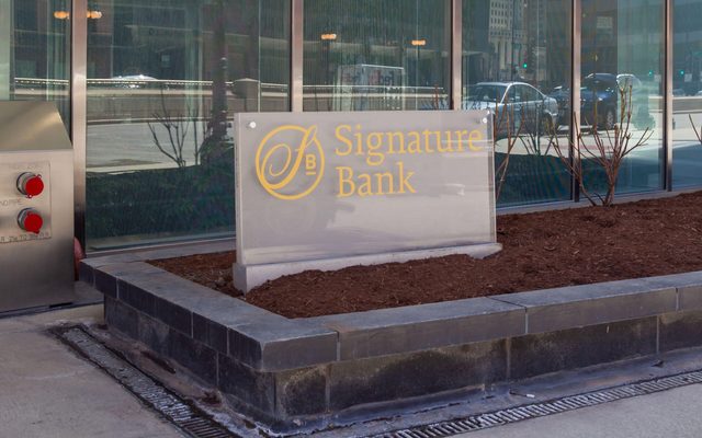 A ground sign for Signature Bank outside the office building in downtown Chicago, Illinois, USA.